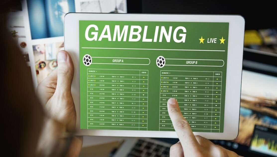 A person using a tablet with a gambling app on it