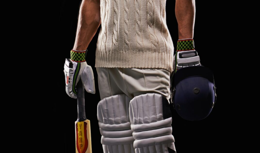 A cropped shot of a young cricketer in his attire isolated on black.